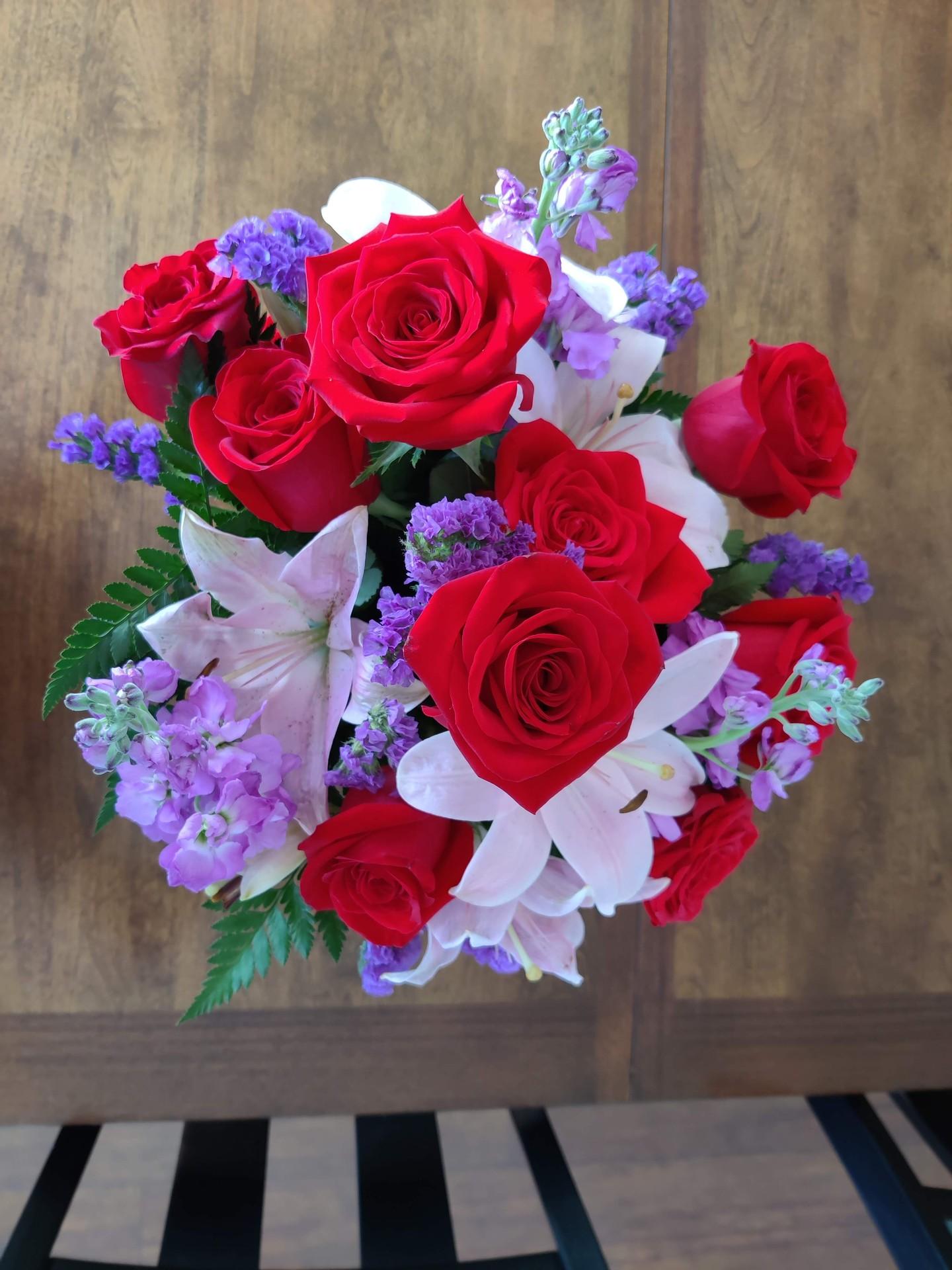 The red roses were incredibly vibrant and added a touch of elegance to the bouquet.